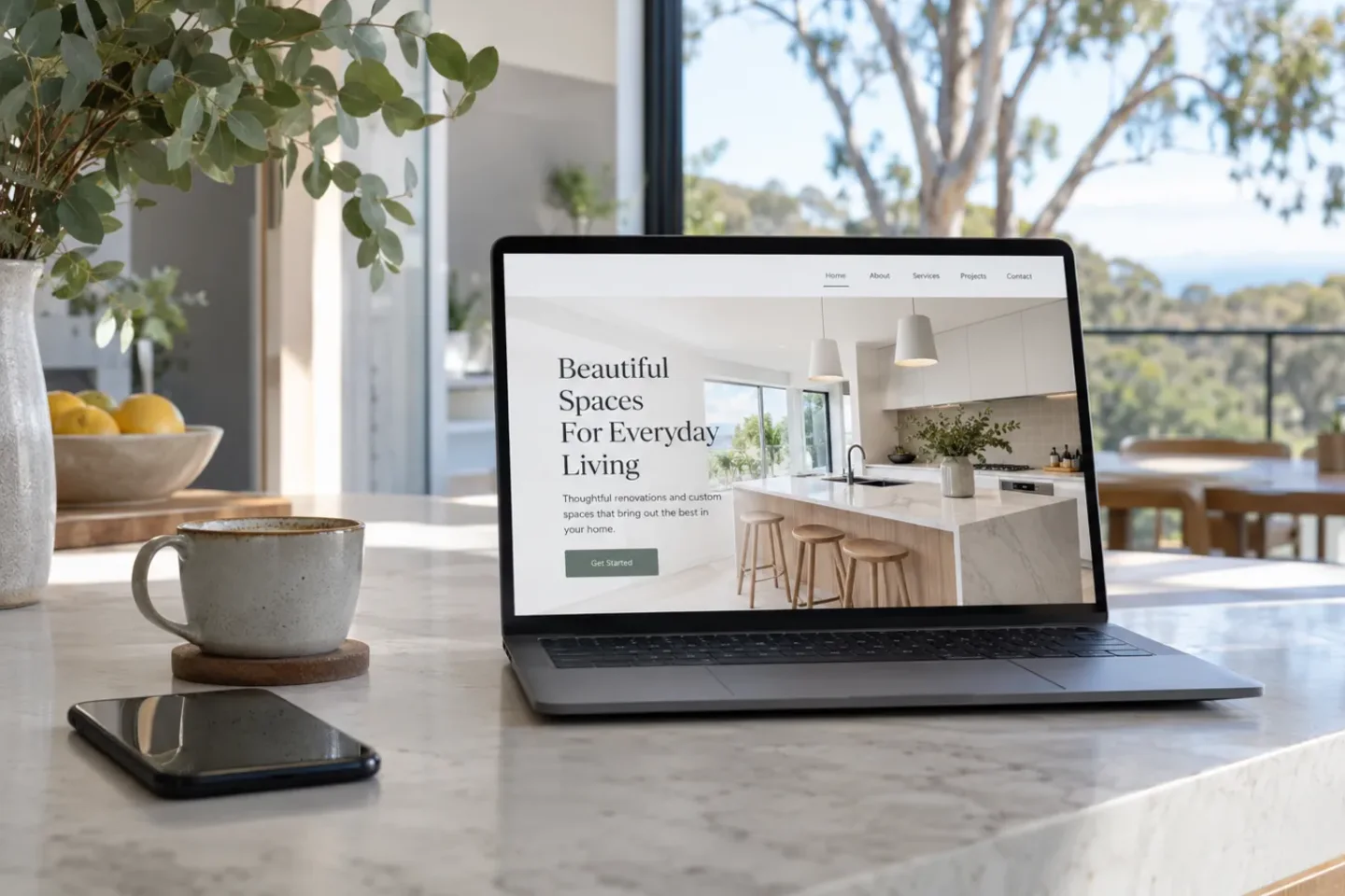 Small business website for a home renovator shown on a laptop in a bright kitchen