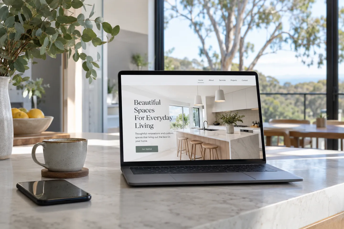 Small business website for a home renovator shown on a laptop in a bright kitchen